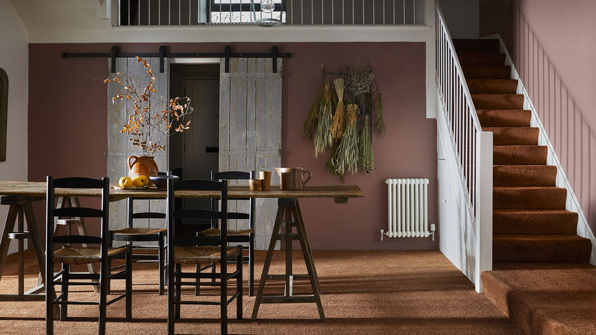 Barn-style room with open staircase, sliding barn doors and brown carpet