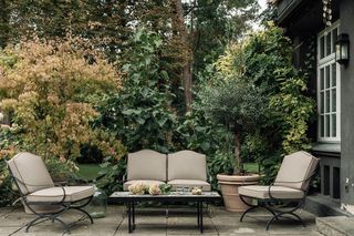 An outdoor living room with garden screen