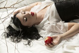 sleeping beauty with an apple in her hand.