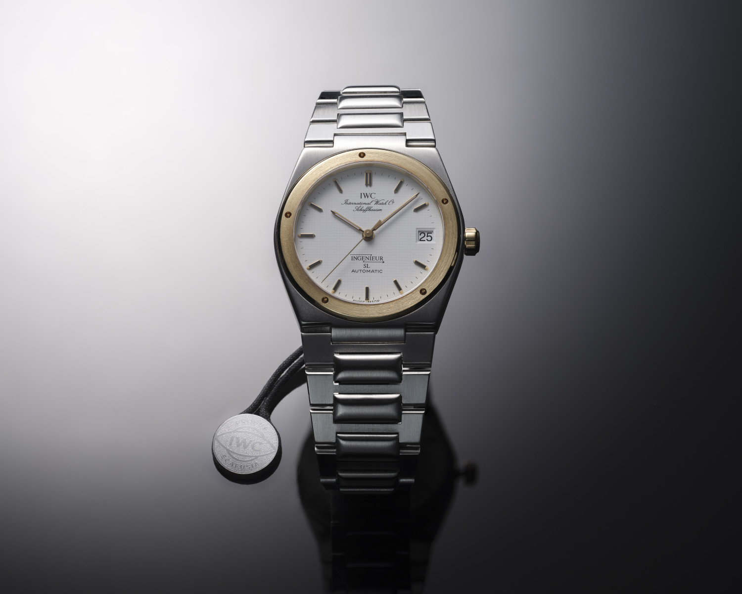 gold and silver IWC watch on a black background