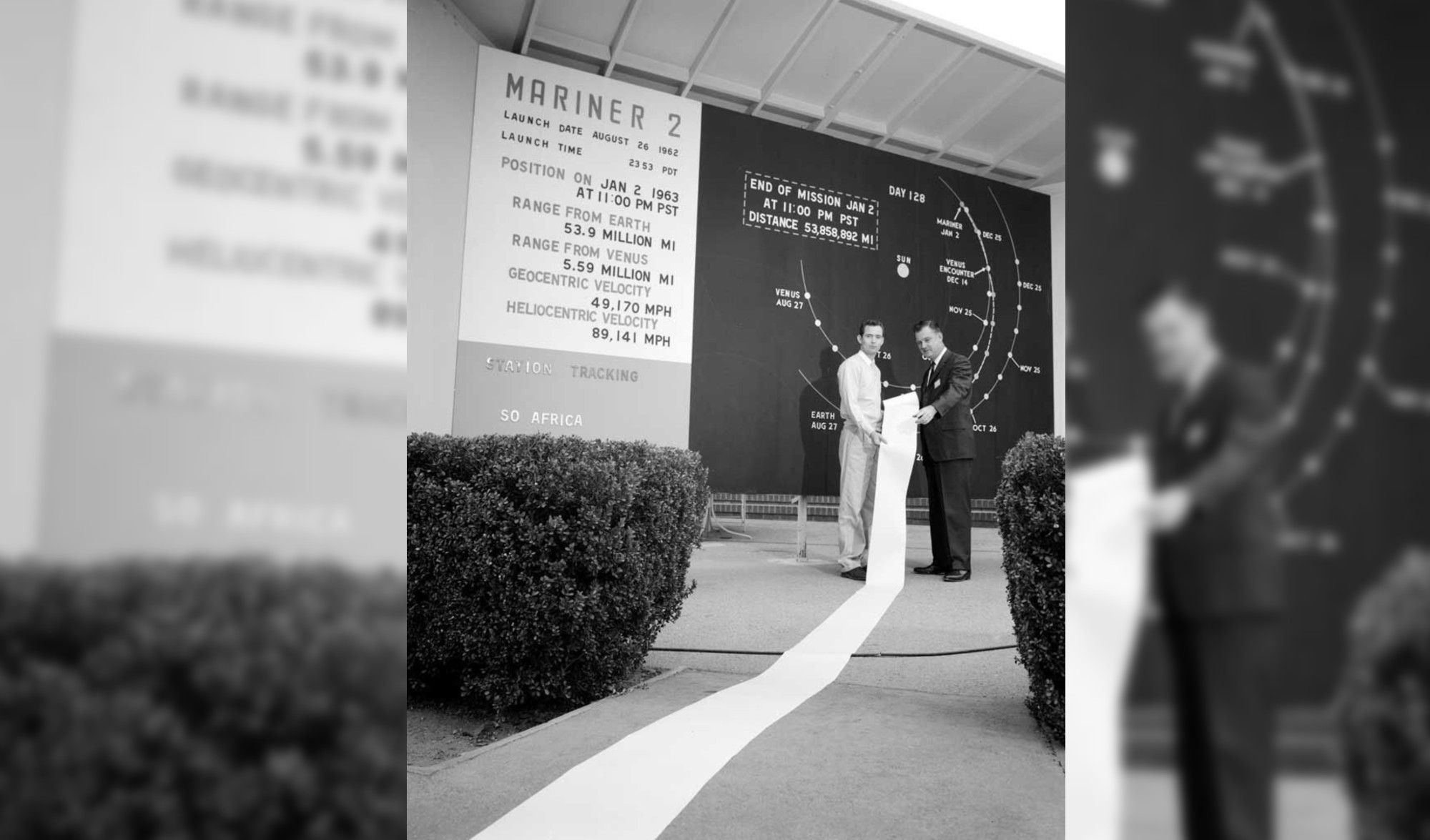 Mariner 2 mission scientists hold a printout of Venus data collected by the spacecraft.