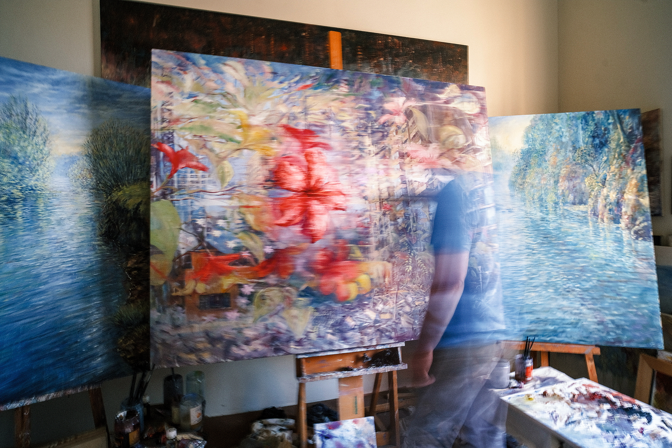The artist painting in his studio.