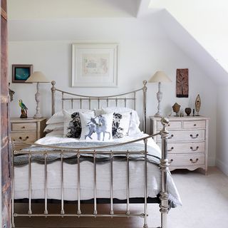 bedroom with chest of drawers and steel bed