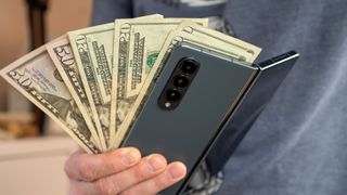 A Samsung Galaxy Z Fold 4 with US dollars