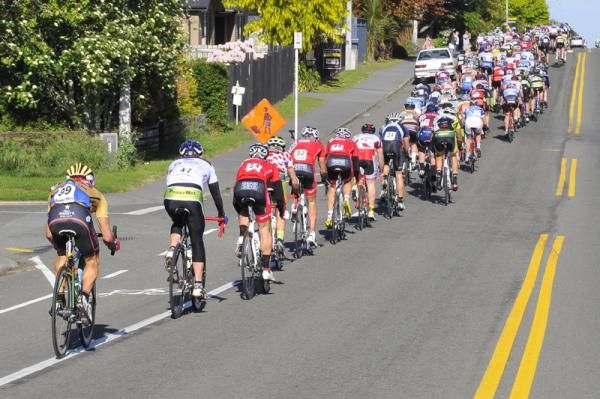 The peloton is in single file as the race gets off to a rapid start