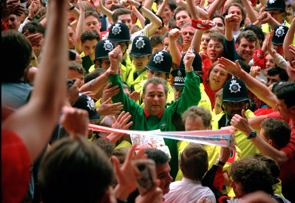 01 May 1993 Premier League - Nottingham Forest v Sheffield United - Police hold back the Forest fans as they invade the pitch to say goodbye to their manager Brian Clough, who raises his arms to salute the supporters. (Photo by Mark Leech/Getty Images)
