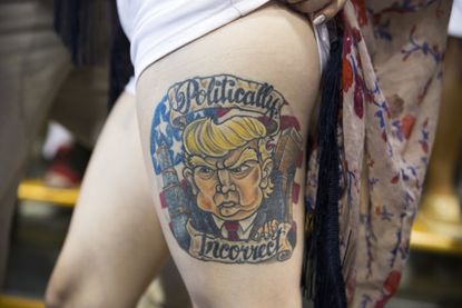 Jennifer Pitta, of Scranton, Pa., shows off a tattoo of Republican presidential candidate Donald Trump during a campaign rally at Lackawanna College