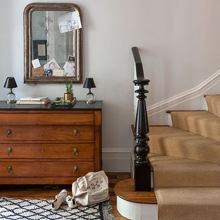 hallway with mirror and wooden drawer