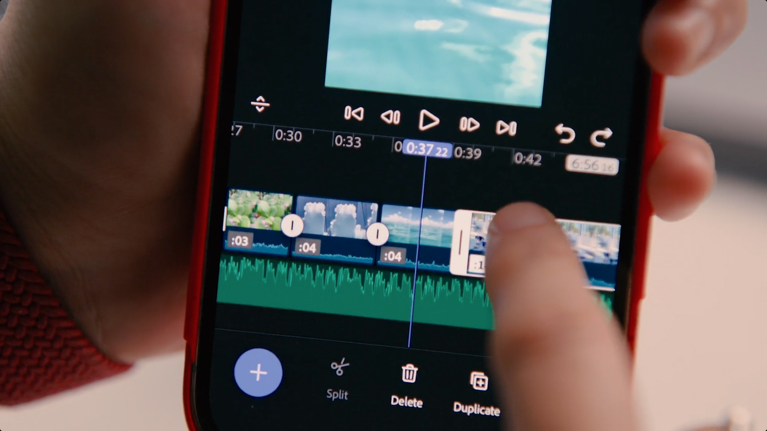 A person uses Adobe Premiere on an iPhone