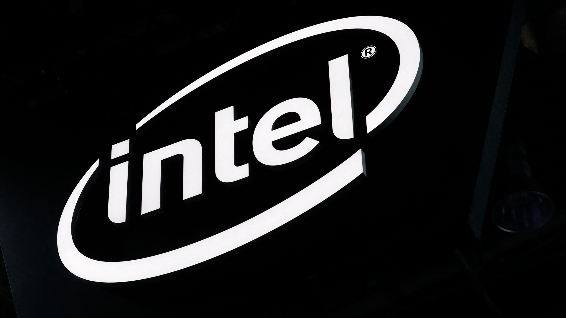 Intel logo illuminated in white against a black background at the Paris Games Week exhibition at the Porte de Versailles exhibition center in Paris.