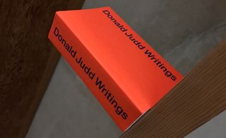The 'Donald Judd Writings' book photographed on a shelf.