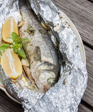 Fresh Fish Prepared with Herbs and Lemon in Foil