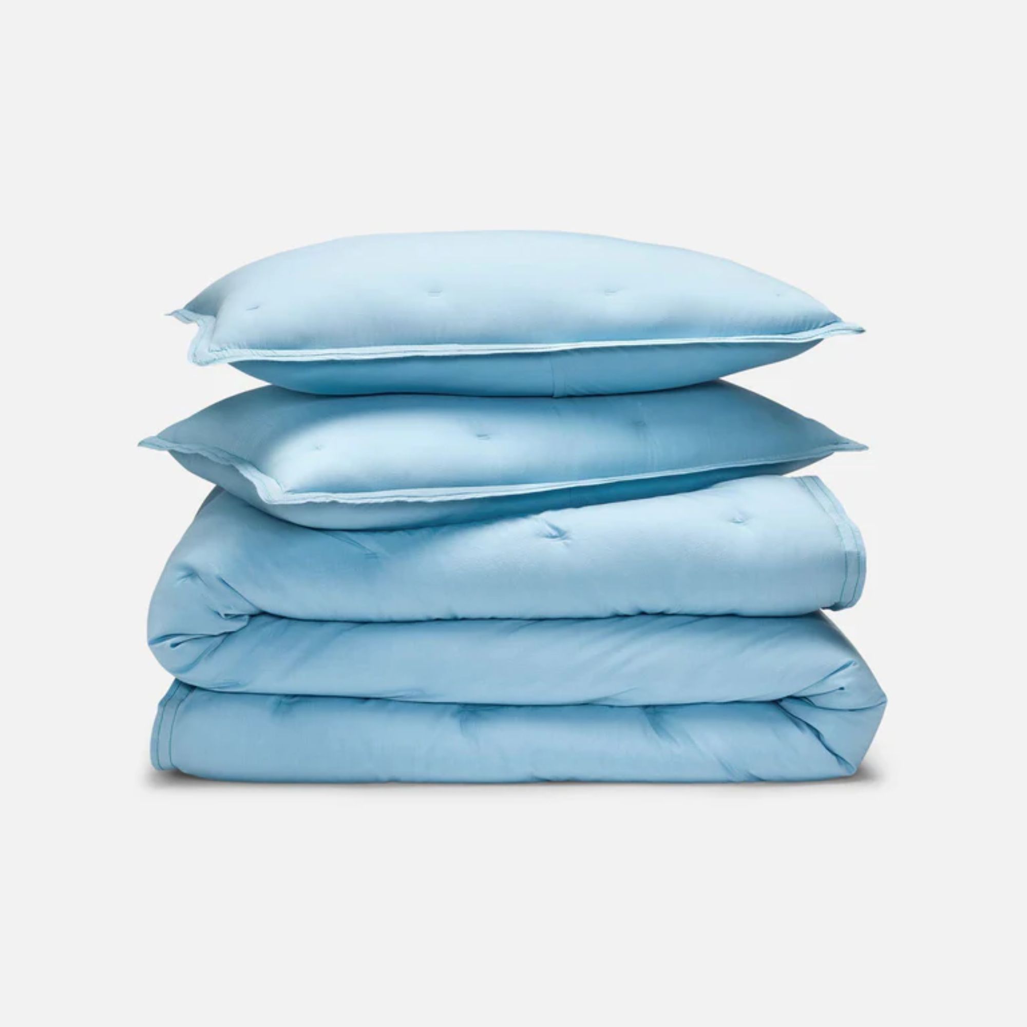 A folded blue washed Classic Percale Comforter Set