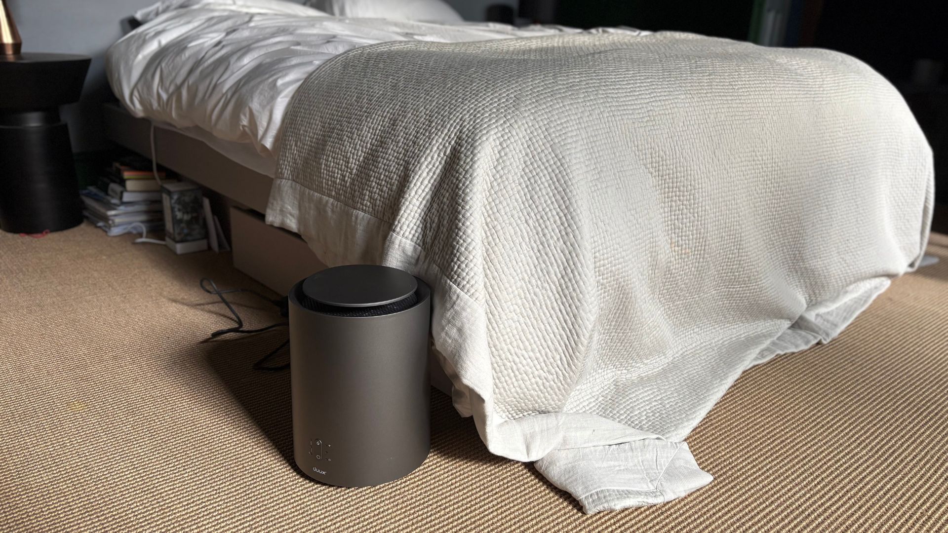 Duux ThreeSixty Smart Ceramic Fan Heater at the foot of the bed