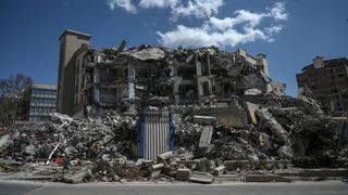 A crumbled building in the wake of an earthquake