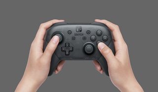 Hands holding a Nintendo Switch Pro Controller