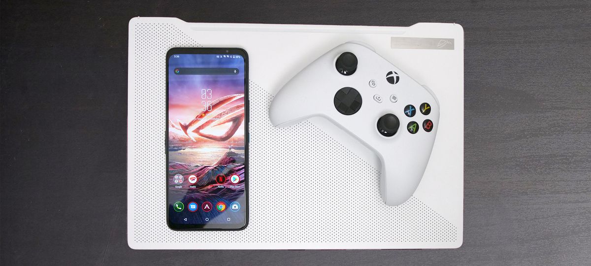 Asus ROG Phone 5 resting on Asus ROG Zephyrus G14 with Xbox Series X controller