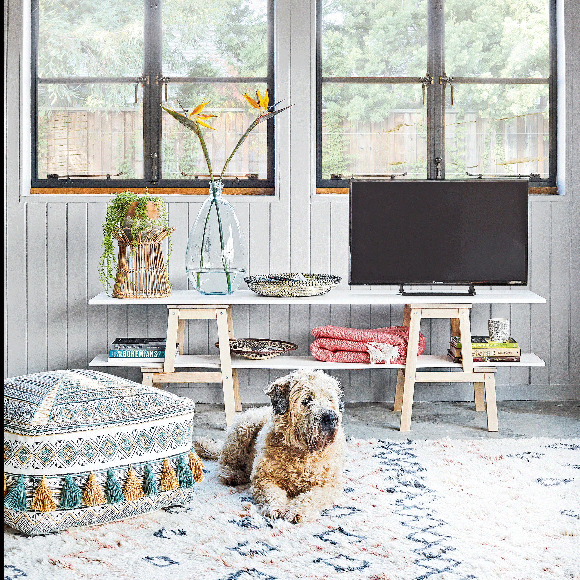 Grey room with berber rug and floor cushion