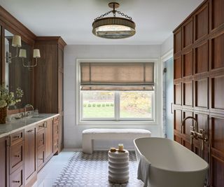 bathroom with freestanding tub and wood paneled walls with geometric tiled floor