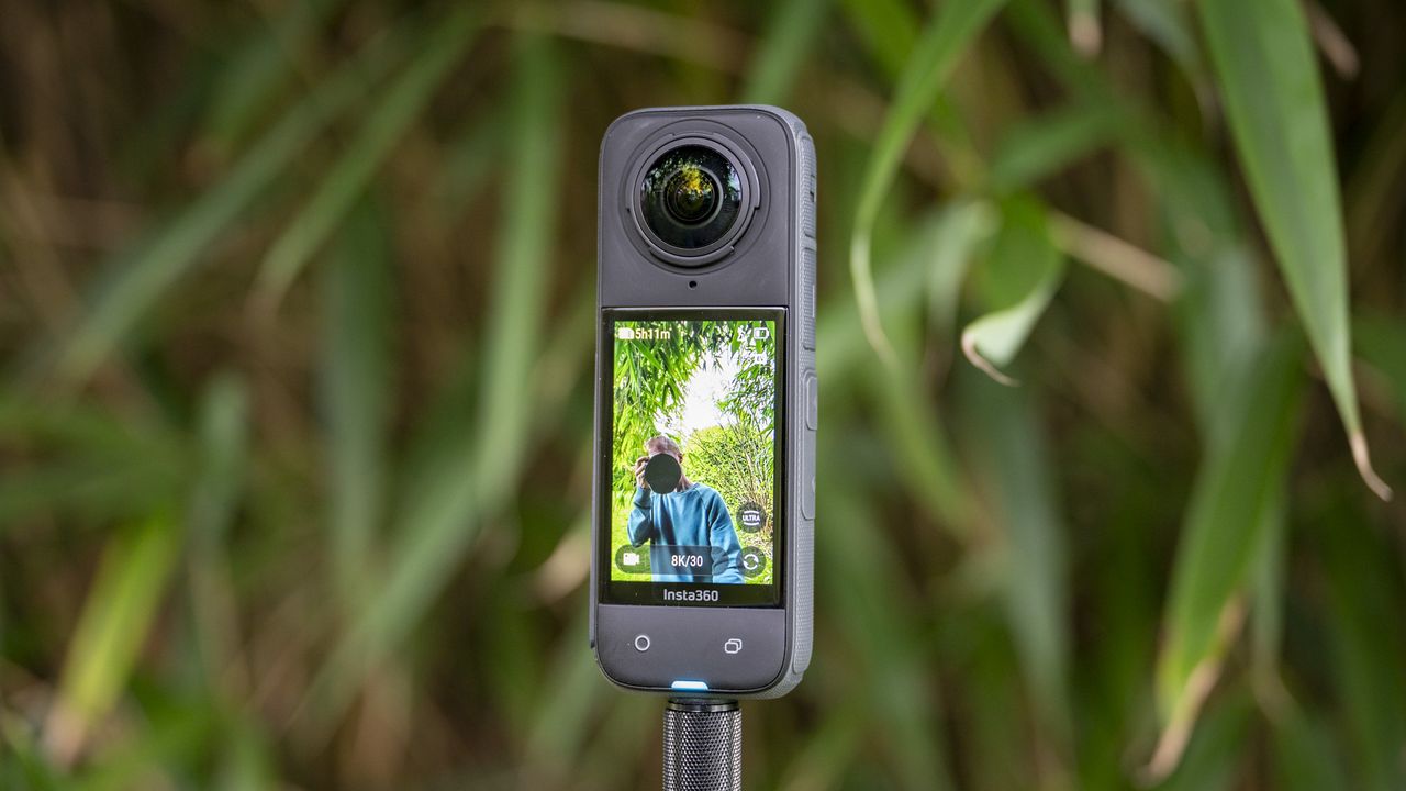 Insta360 X4 360 degree camera on a selfie stick recording video