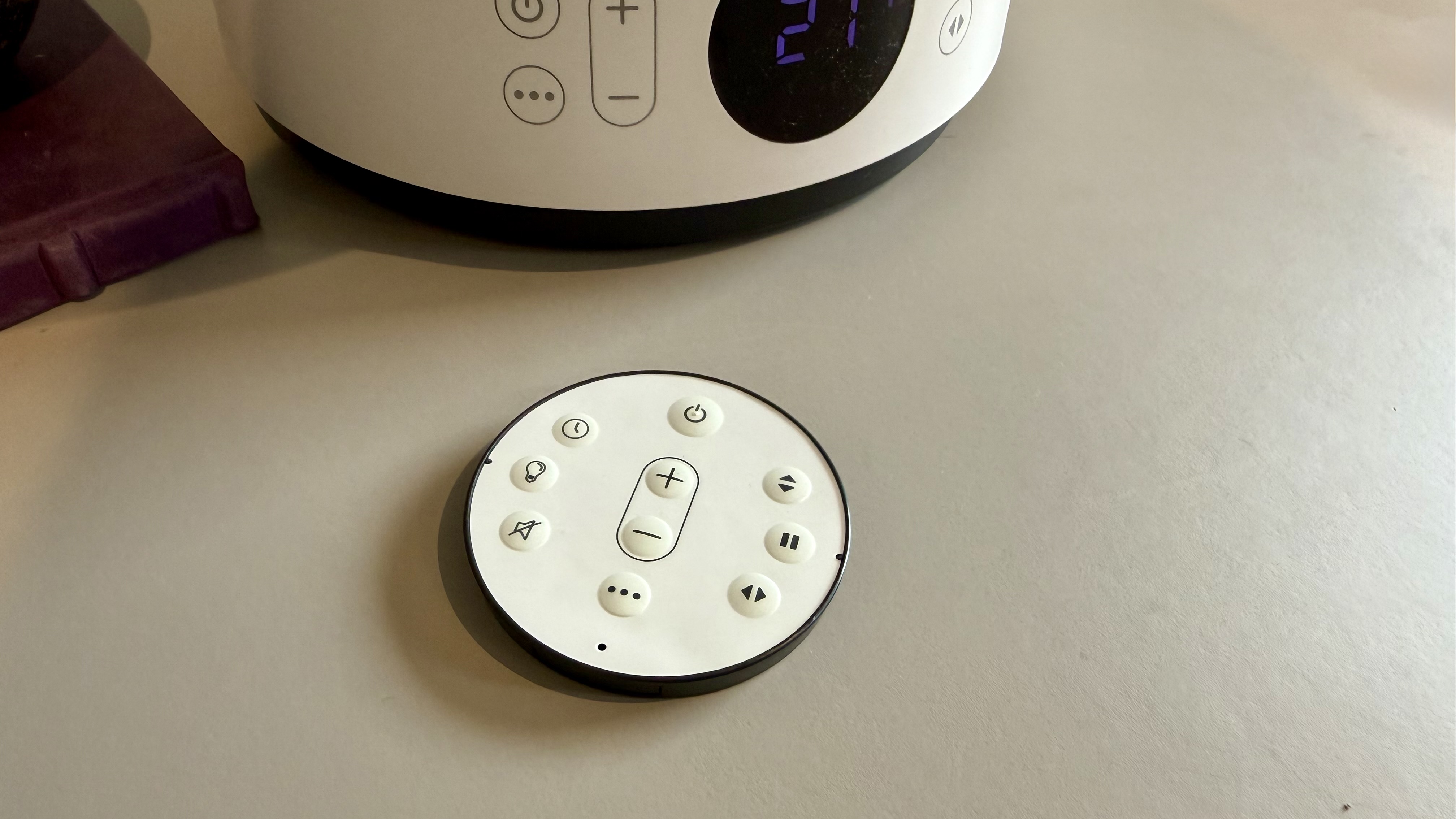 The MeacoFan Sefte Pro 10" Table Air Circulator remote control pictured on a grey table