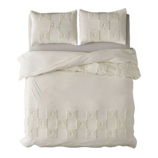 A cream duvet cover with raised tufts