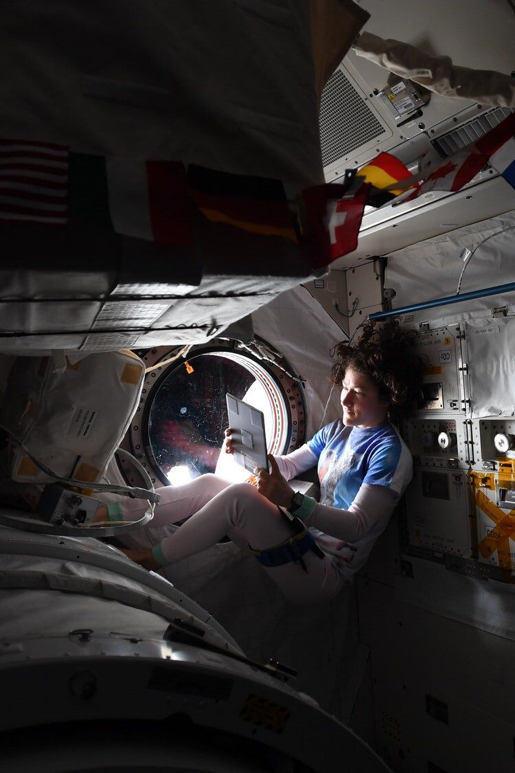 NASA astronaut Christina Koch relaxes by a window on the International Space Station to mark the U.S. Labor Day holiday on Sept. 2, 2019.