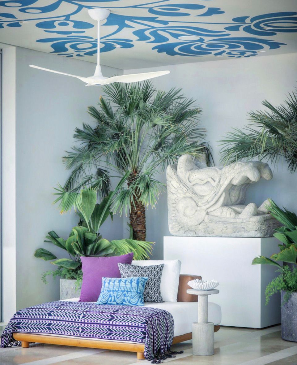 bedroom with palm trees and white and blue wallpaper on the ceiling