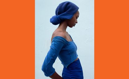 Model wears blue knitted top skirt and turban by Talia Byre