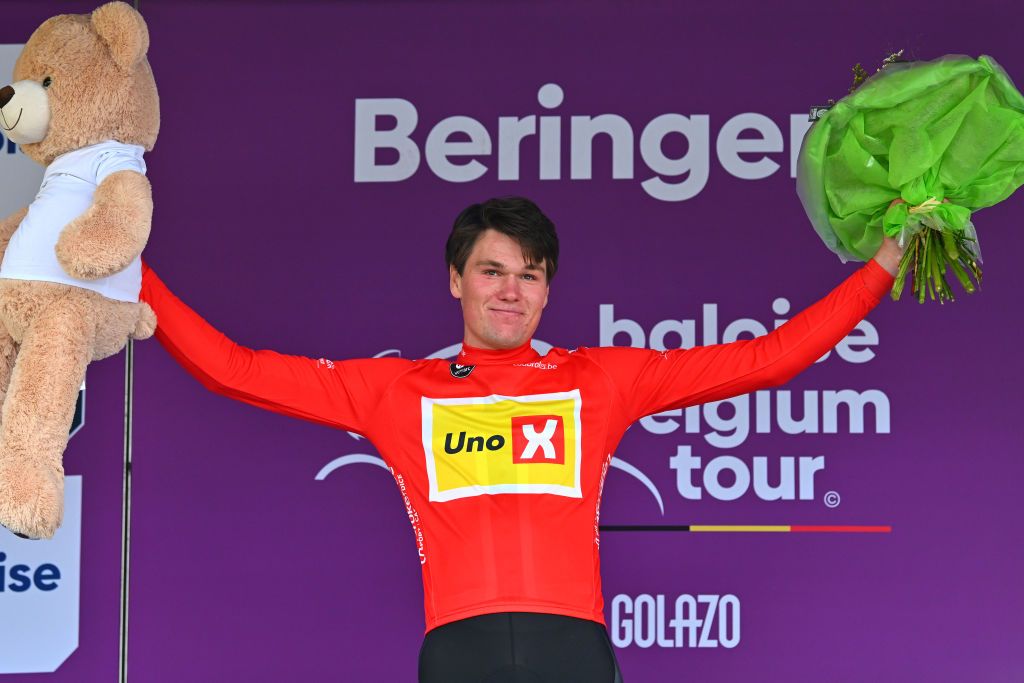 TURNHOUT BELGIUM JUNE 12 Soren Waerenskjold of Norway and Team UnoX Mobility celebrates at podium as Red Points Jersey winner during the 93rd Baloise Belgium Tour 2024 Stage 1 a 12km individual time trial stage from Beringen to Beringen on June 12 2024 in Beringen Belgium Photo by Luc ClaessenGetty Images