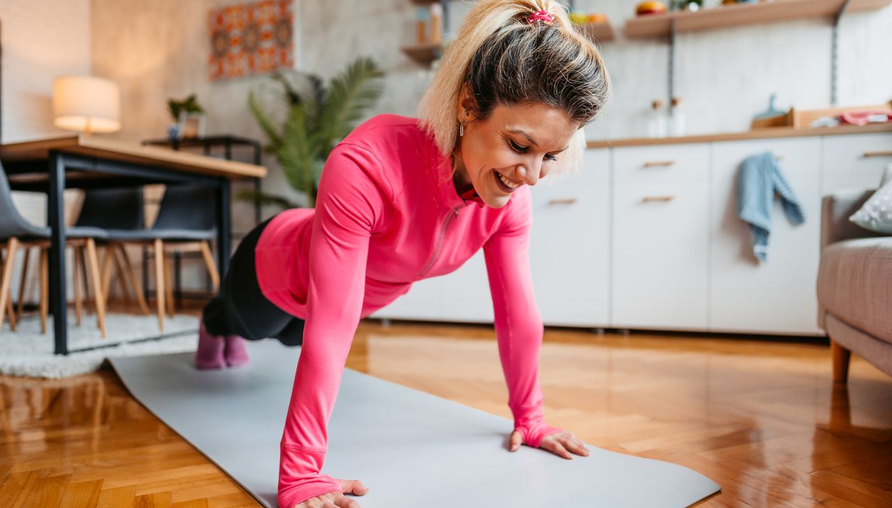 Woman in high plank position about to do a push-up