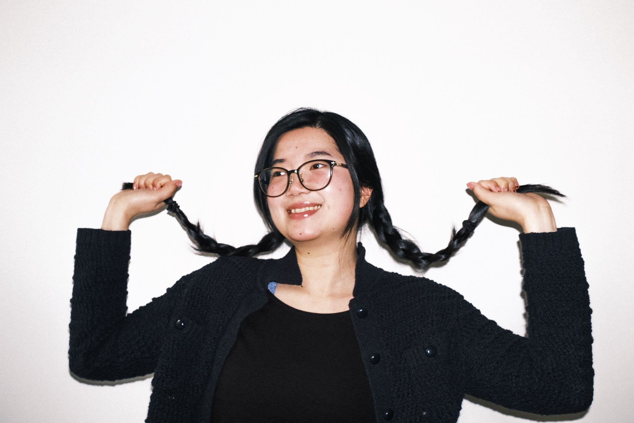 Eido Hayashi, a woman with glasses and braids