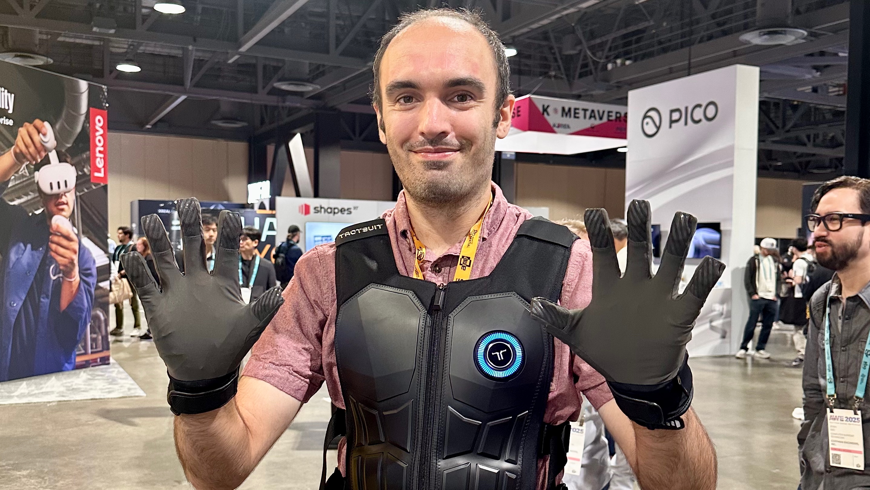 The author wearing a bHaptics vest and haptic gloves for VR gaming.