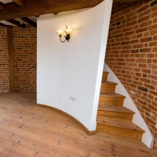 mill interior with brick wall staircase and wooden floor