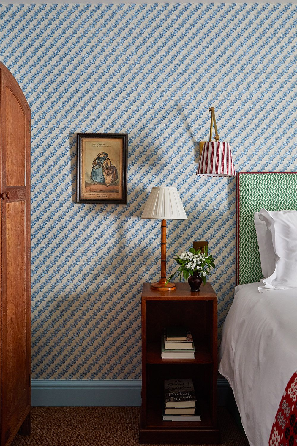 Bedroom with blue patterned wallpaper and glossy blue skirting board