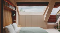 Loft bedroom with huge skylight, built-in headboard with shelving