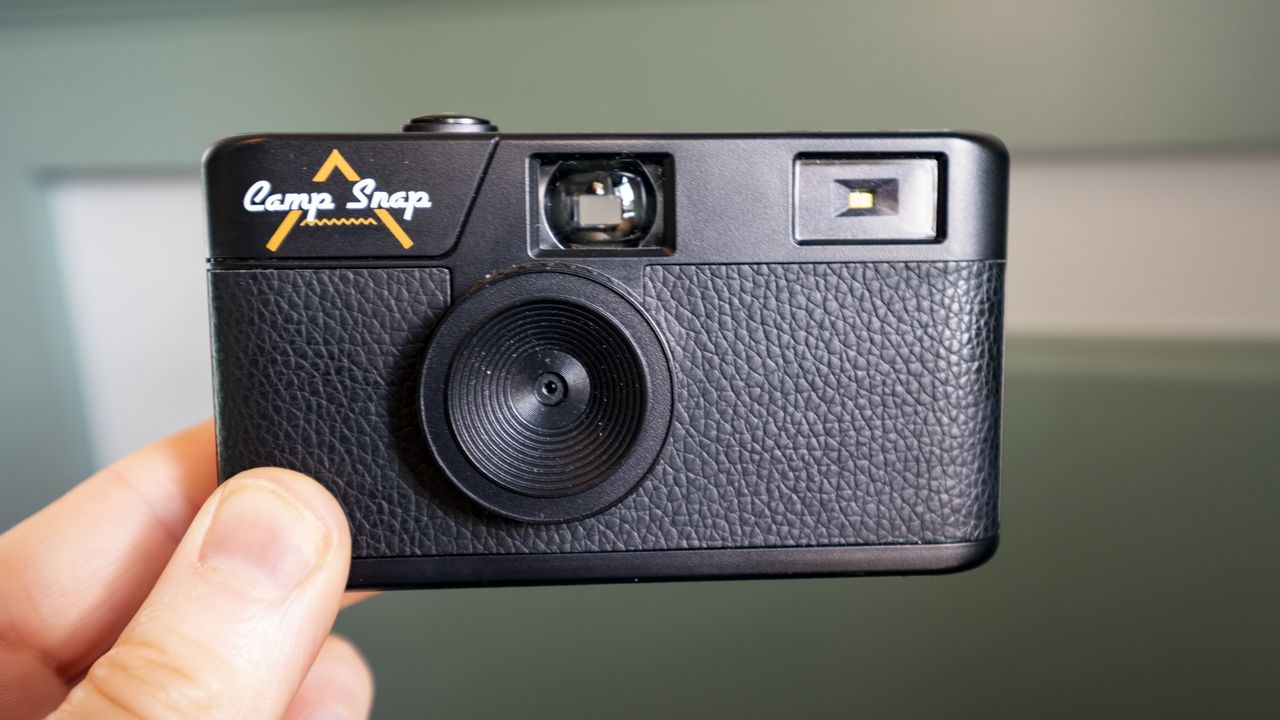 Camp Snap Camera in the hand illuminated by window light