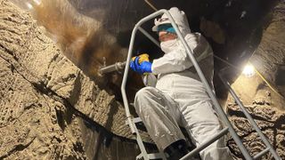 A researcher drills a sample of the permafrost in the Permafrost Research Tunnel in Alaska.