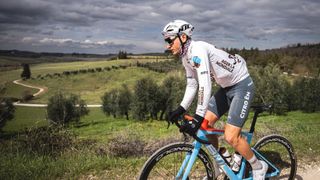 AG2R rider in denim cycling shorts in the Tuscan hills