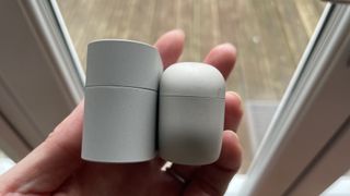 The Sony WF-10000XM6 next to the Sony WF-1000XM5, held in a hand, to show the size difference