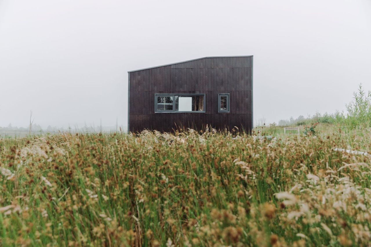 The exterior of the tiny eco home clad in wood