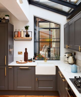 grey shaker style kitchen with gold handles and belfast sink
