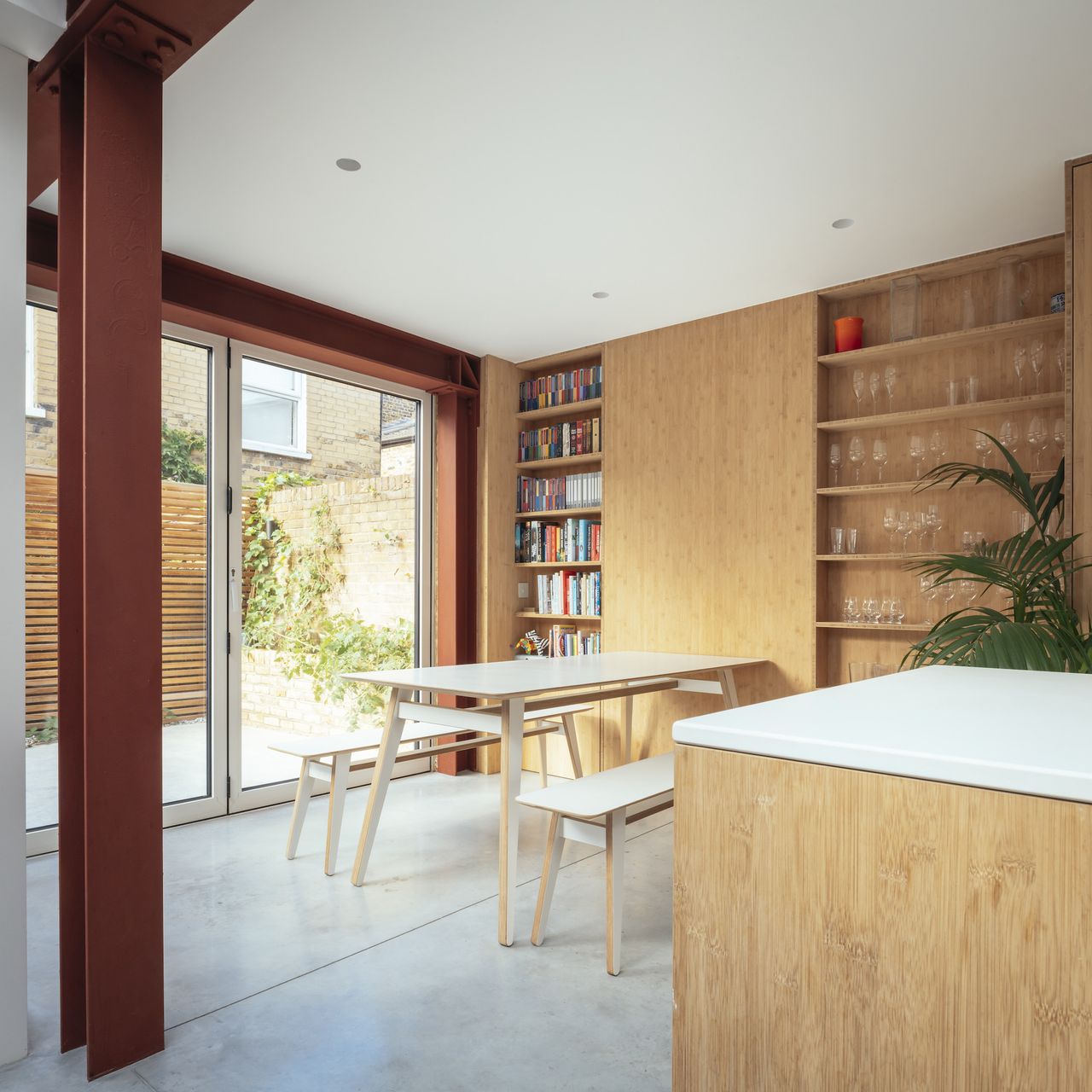 modern kitchen and dining room with wooden bookcases