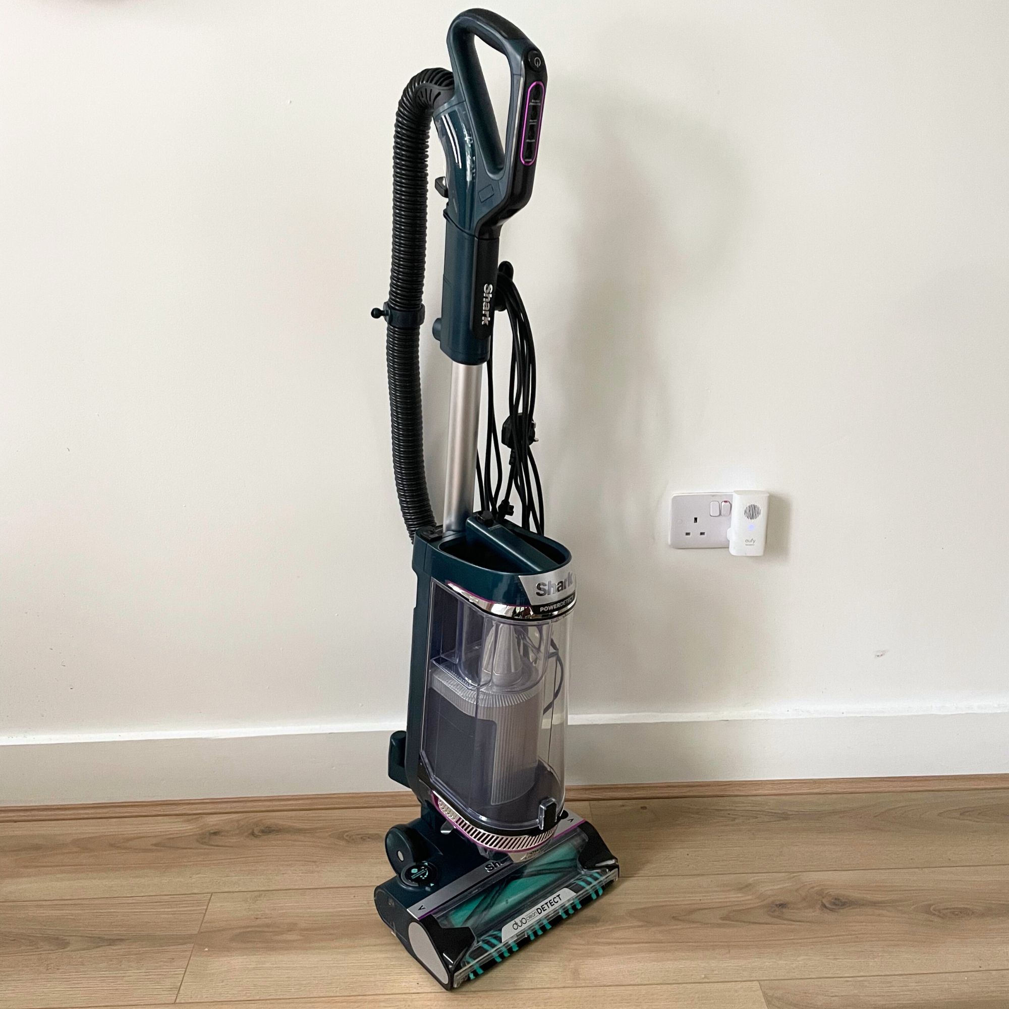 Shark PowerDetect Powered Lift-Away Upright Pet Vacuum Cleaner AZ3900UKT on wood-effect flooring, in front of a white painted wall