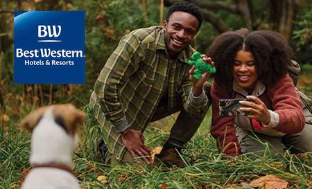 Best Western Logo placed over an image of a father and daughter taking a photo of a dog