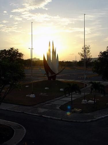 Sunset behind Pan Am flame statue.