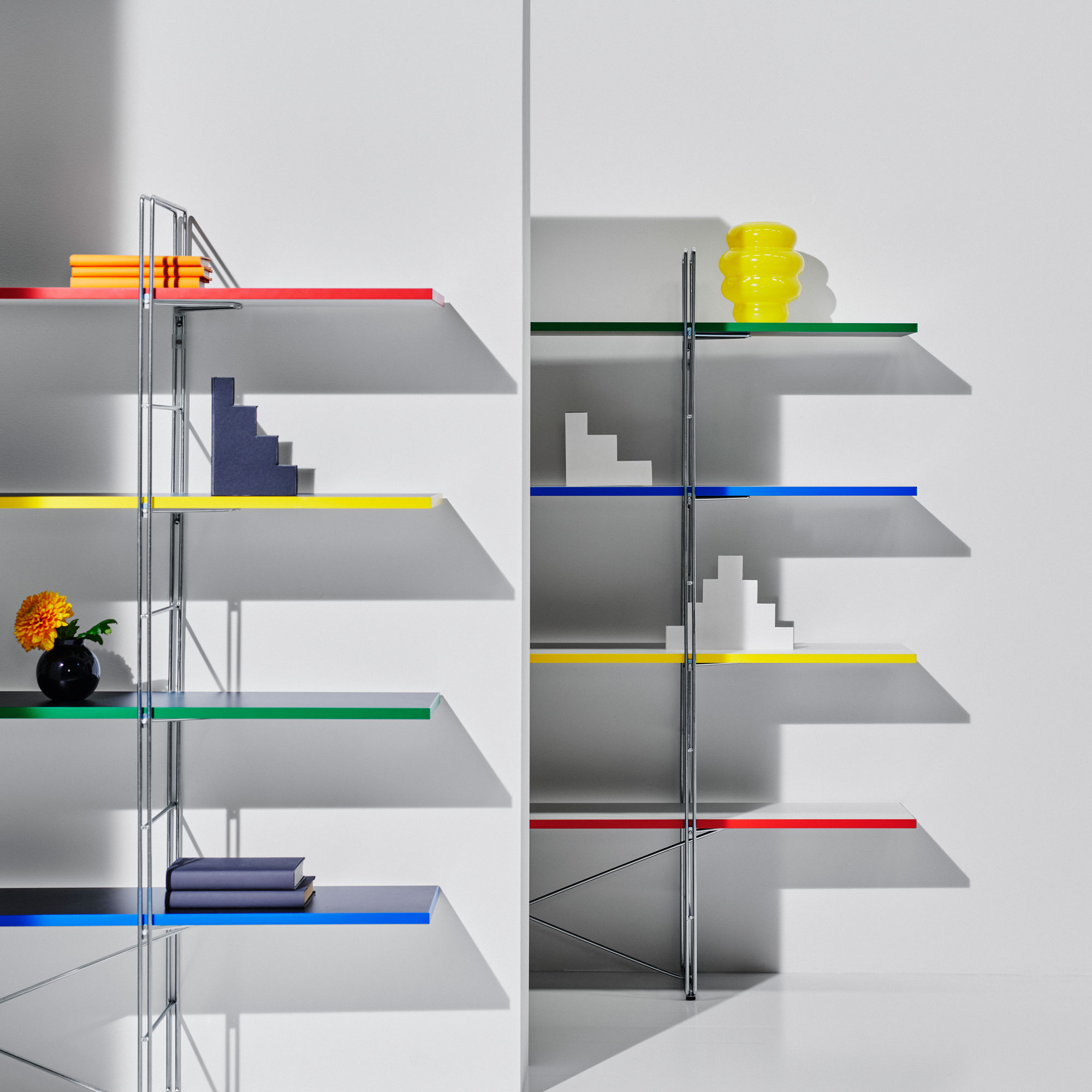 IKEA open shelving with coloured edges and metal frame in a white room