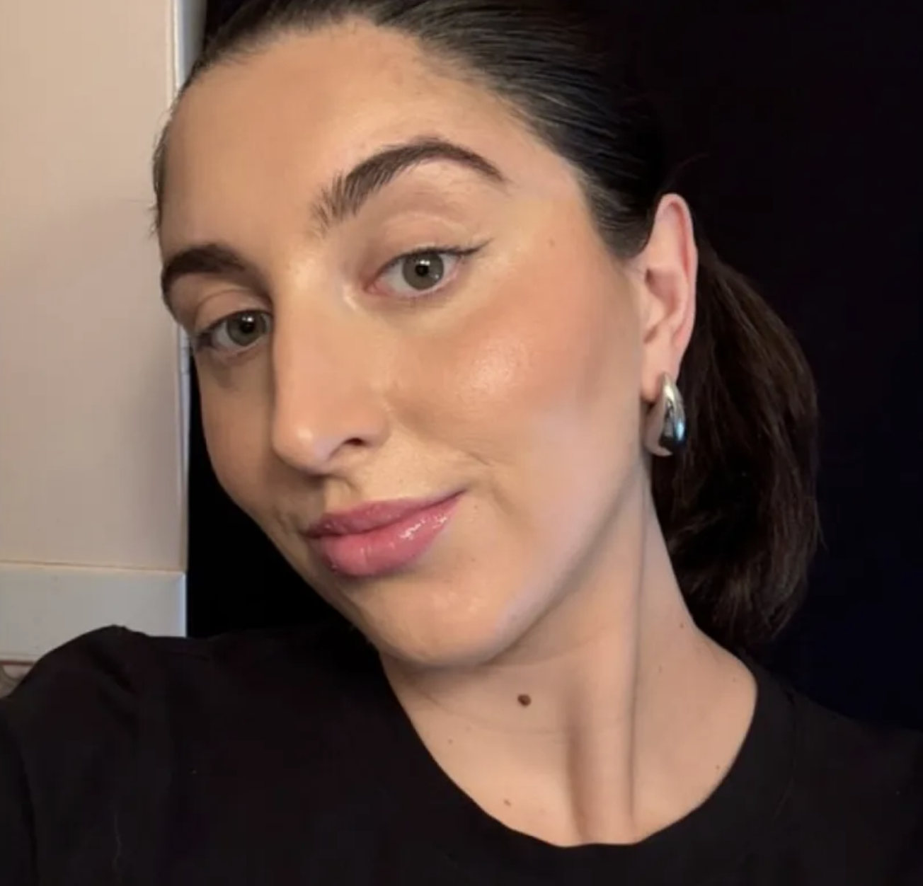 a girl with brown hair after using the Versed Skin Solution Multi-Serum Skin Tint Foundation.