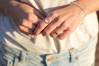 Female hand with silver jewelry, rings and bracelets minimalistic style