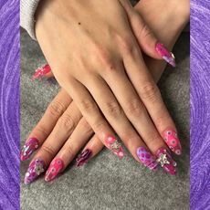 a pink and purple manicure on a purple background